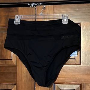 Black bikini bottom with sheer detailing.